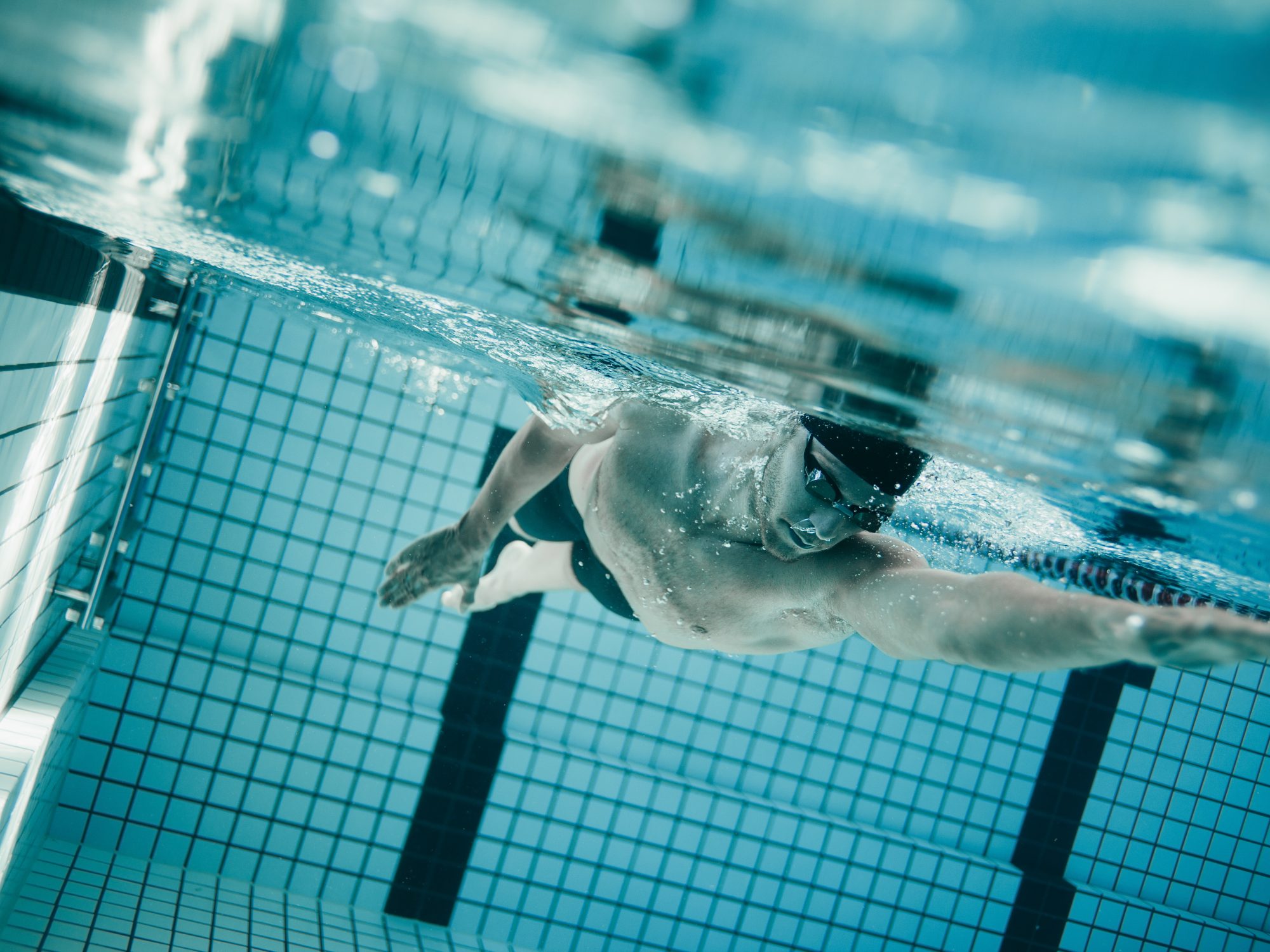 Professional male swimmer inside swimming pool